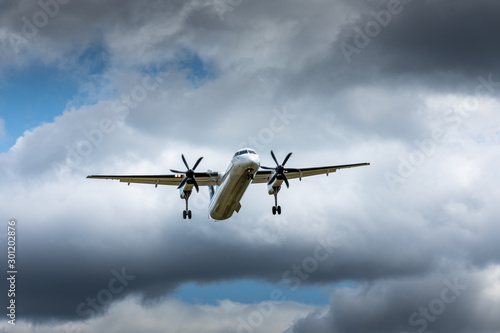 Fototapeta Naklejka Na Ścianę i Meble -  Propeller airplane flying in the cloudy skies