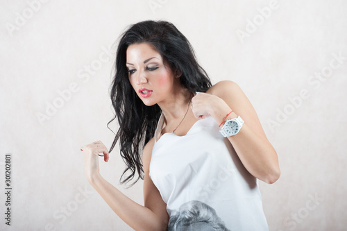 girl with a white clock. Brunette with makeup posing on a white background