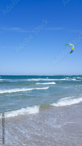 The sea is agitated. Beautiful waves on a sandy beach. Sea, waves, and blue sky.