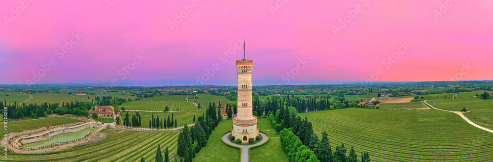 The Tower of San Martino della Battaglia  a monumental tower erected in 1878 to commemorate the Battle of Solferino, Italy . Pink sky sunset
