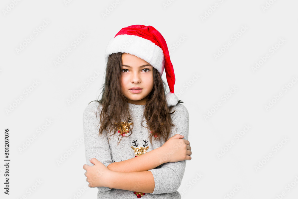 Little girl celebrating christmas day going cold due to low temperature or a sickness. Little girl celebrating christmas day going cold due to low temperature or a sickness.