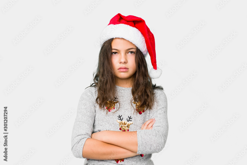 Little girl celebrating christmas day tired of a repetitive task. Little girl celebrating christmas day tired of a repetitive task.