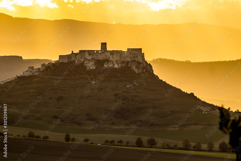 Sunset over the Spis Castle in backround with wonderful scenery of High Tatras Mountains, Slovakia