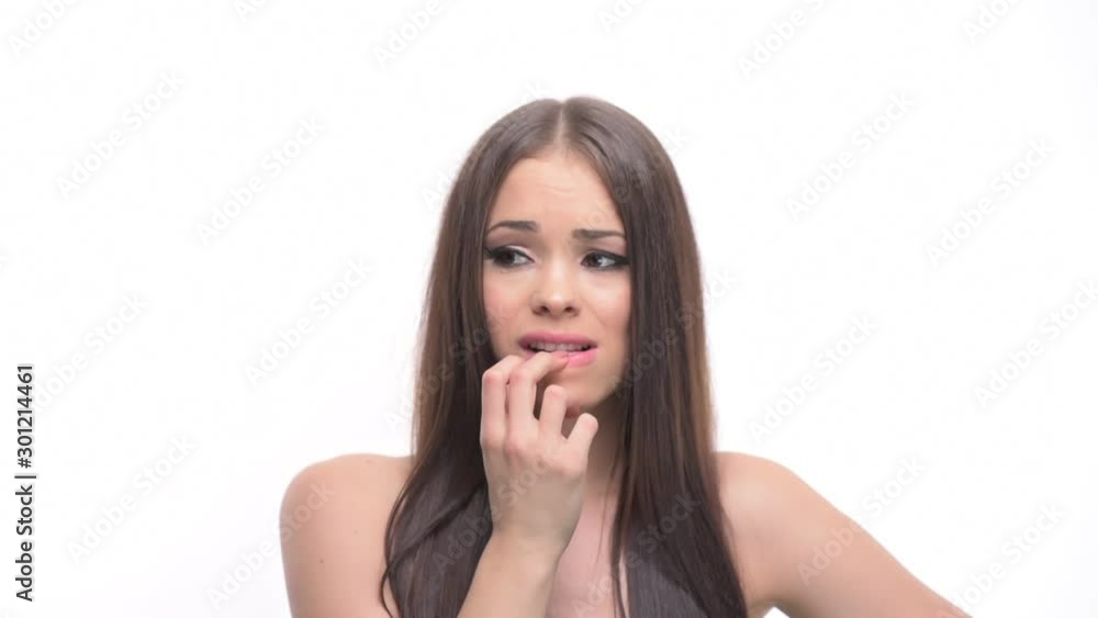 Nervous anxious waiting young girl biting finger nails looking around isolated on white background. Nervous anxious waiting young girl biting finger nails looking around isolated on white background.