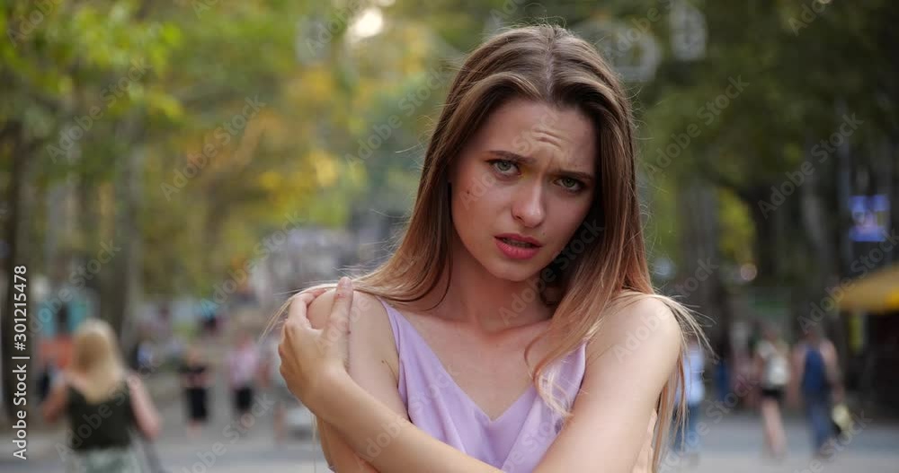 Beautiful upset young woman on city street Beautiful upset young woman on city street