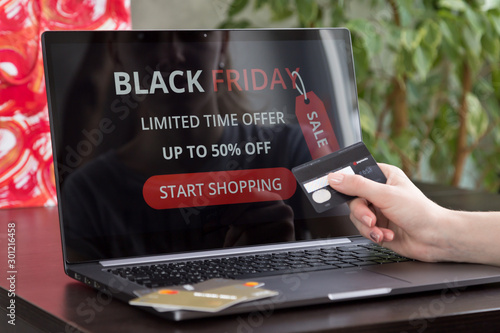 Girl makes purchases over the internet on black friday