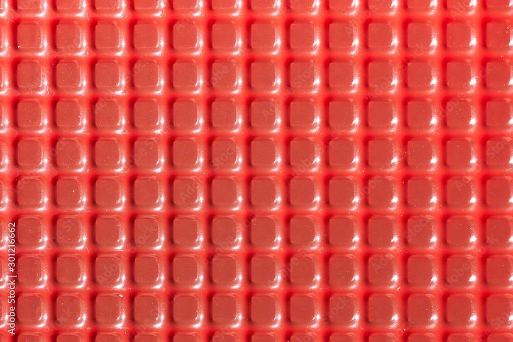 Fototapeta premium Texture with square red elements. Plastic candy lining