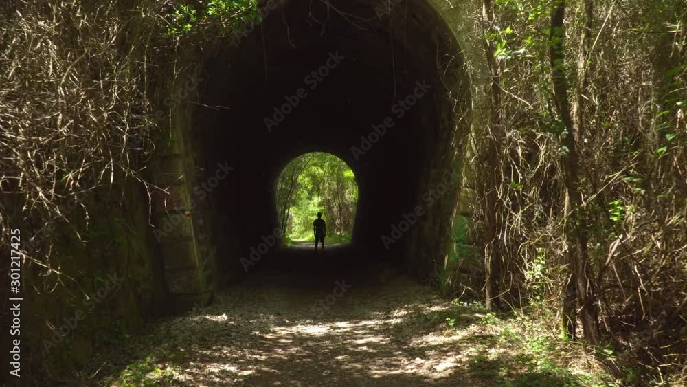 Approach of camera to man still in a tunnel Approach of camera to man still in a tunnel
