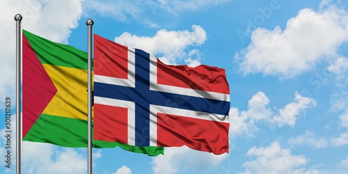 Sao Tome And Principe and Norway flag waving in the wind against white cloudy blue sky together. Diplomacy concept, international relations.