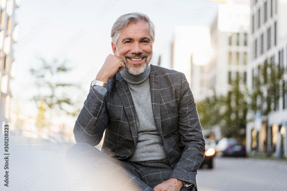 Portrait of smiling fashionable mature, businessman in the city Portrait of smiling fashionable mature, businessman in the city