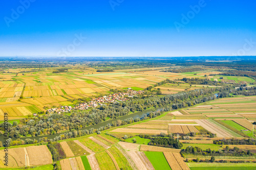 Beautiful countryside landscape in Croatia  near Sisak  Sava river meandering between agriculture fields  aerial shot from drone