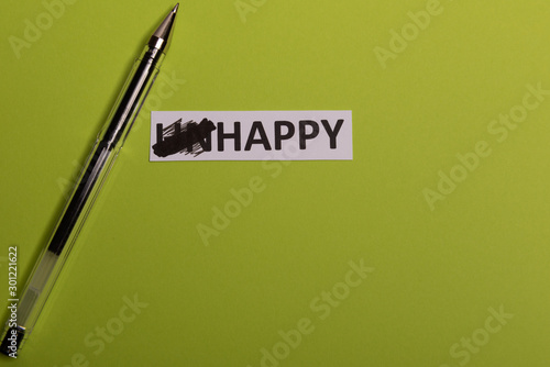 card with text unhappy, erease word 'un' so it written 'happy'. Copy space. Lime background. Studio shoot photo