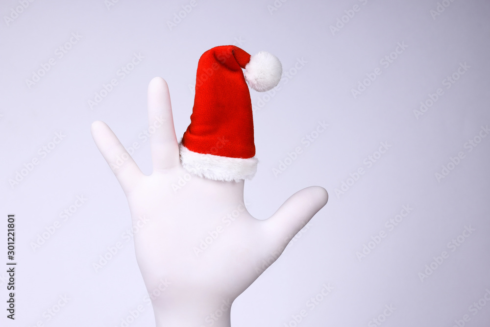 White hand with Santa Claus heat on finger. Christmas and New Year holidays concept. White hand with Santa Claus heat on finger. Christmas and New Year holidays concept.