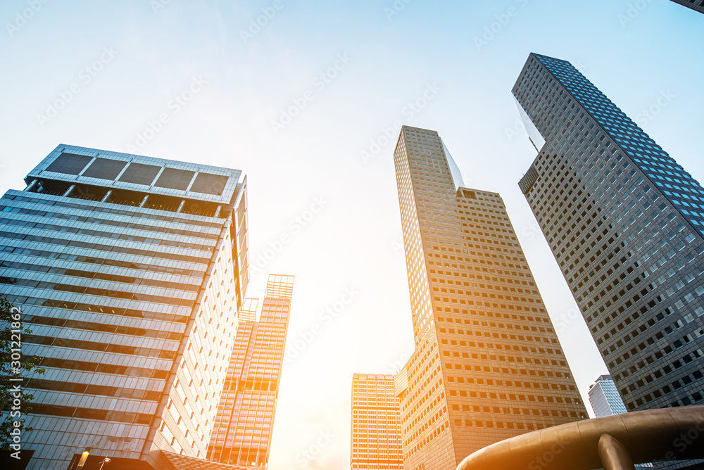 Obraz premium Modern business skyscrapers, high-rise buildings, architecture raising to the sky, sun. Concepts of financial, economics, future etc.