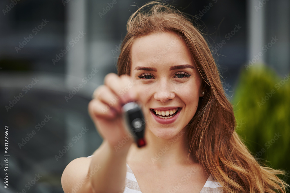 Portrait of cheerful blonde with keys of her brand new car Portrait of cheerful blonde with keys of her brand new car