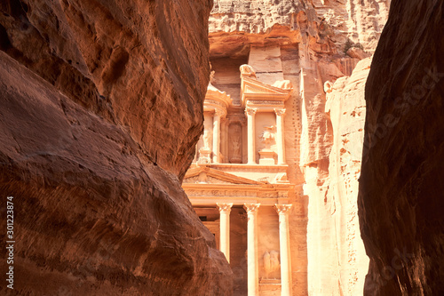 Al-Khazneh or Treasury facade between rocks in ancient city of Petra, Jordan