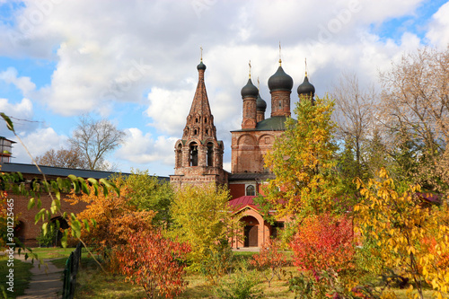 View of the old russian red brick church in Krutitsy Patriarchal Metochion surrounded by colorful autumn trees, Moscow, Russia