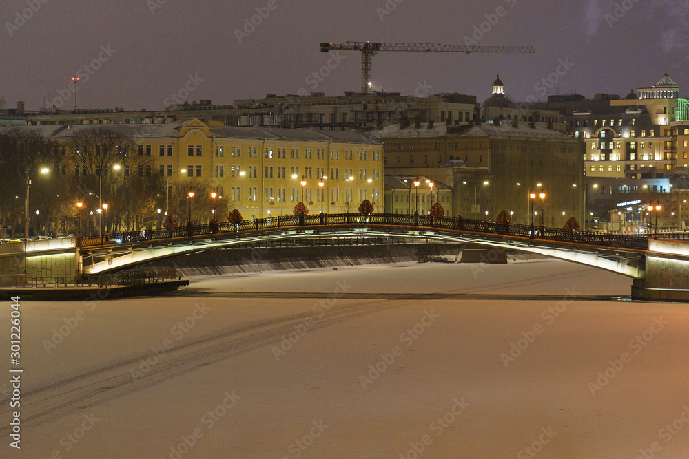 Beautiful winter night in the city Moscow. Water in the river had been covered by snow. Suitable for greeting cards, postcards, posters.