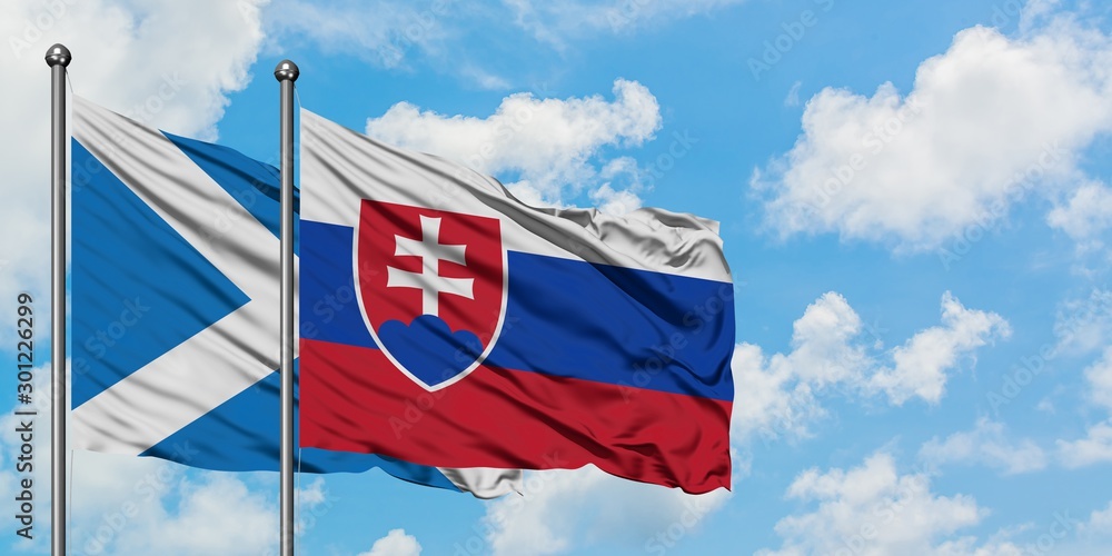Scotland and Slovakia flag waving in the wind against white cloudy blue sky together. Diplomacy concept, international relations.