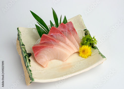 Sliced raw Hamachi sashimi on plate photo