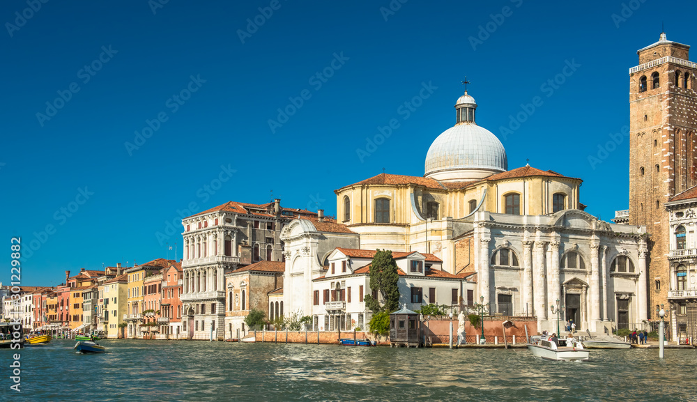 Venice Grand Canal with colorful facades of old medieval houses , Italy. Venice is a popular tourist destination of Europe.