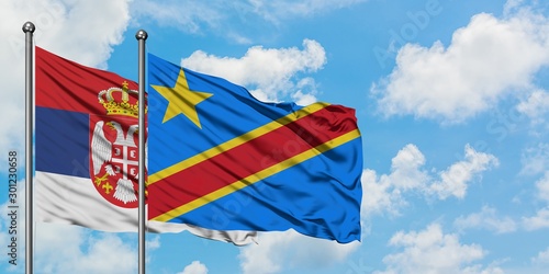 Serbia and Congo flag waving in the wind against white cloudy blue sky together. Diplomacy concept, international relations.