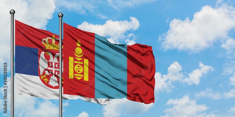 Serbia and Mongolia flag waving in the wind against white cloudy blue sky together. Diplomacy concept, international relations.