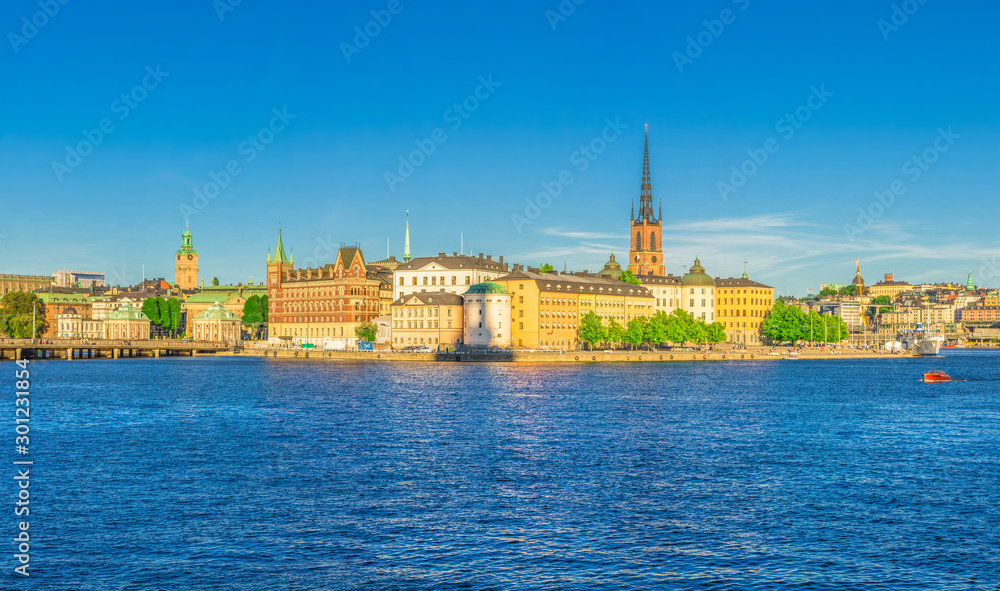 Panoramic view of Riddarholmen island district, Riddarholm Church spires, typical sweden colorful gothic buildings, Birger jarls torn, Lake Malaren water, blue clear sky background, Stockholm, Sweden