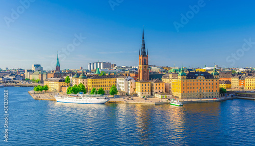 Aerial scenic panoramic view of Stockholm skyline with Old town Gamla Stan, typical Sweden houses, Riddarholmen island with gothic Church building, Lake Malaren, clear blue sky background, Sweden photo