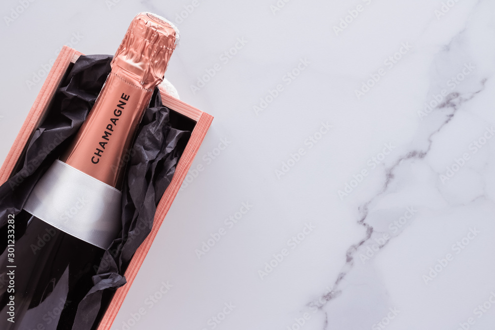 Champagne bottle and gift box on marble, New Years, Christmas, Valentines Day or wedding holiday present and luxury product packaging for beverage brand - obrazy, fototapety, plakaty 