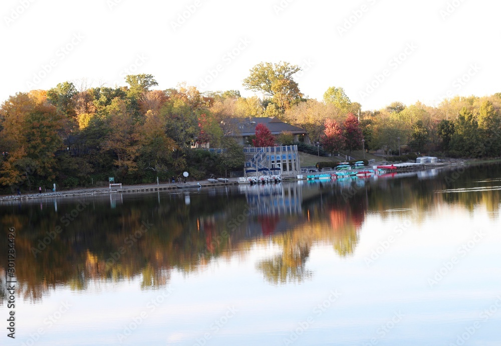 A evening view of the boathouse at the lake in the park.
