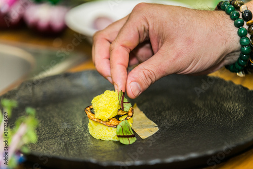 Close up hands of chef preparing food in the kitchen of a restaurant, cooking concept