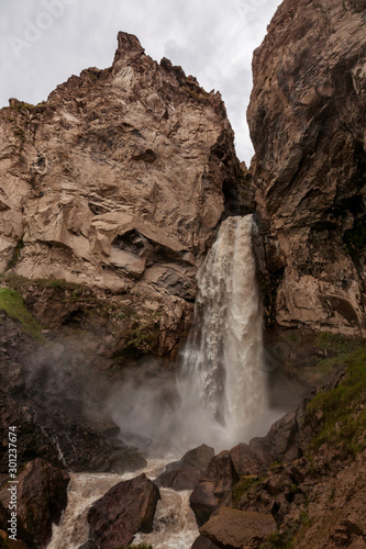 mountain waterfall among rocky landscape and splashes