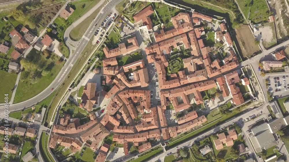 Top down aerial view of a small historic town Venzone in Northern Italy with red tiled roofs of old buildings. Top down aerial view of a small historic town Venzone in Northern Italy with red tiled roofs of old buildings.