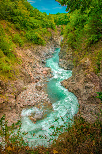 The mountain river flows through the canyon. Mountain river