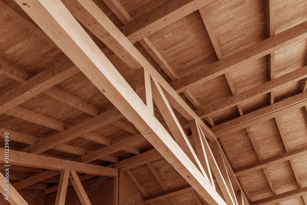 The construction of a wooden roof made of timber. - obrazy, fototapety, plakaty 