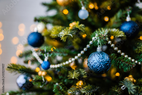 Dressed up Christmas tree. Gold and blue Christmas tree decorations for Christmas.