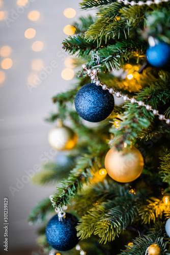 Dressed up Christmas tree. Gold and blue Christmas tree decorations for Christmas.