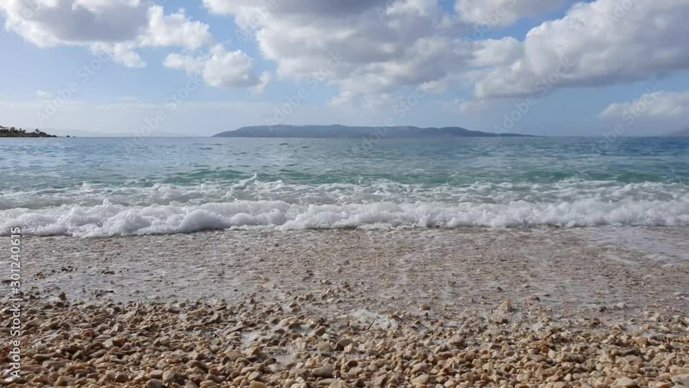A pebble beach and waves flooding the coast. Makarska main beach - Croatia. Slow motion shot A pebble beach and waves flooding the coast. Makarska main beach - Croatia. Slow motion shot