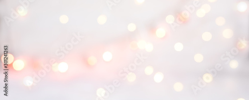 Abstract texture of bokeh christmas lights in rose. Sparkling lights product background.