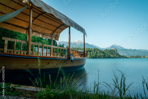 View of a beautiful typical boat from Bled called  pletna   that makes excursions to the Bled island. Long exposure photographic technique.