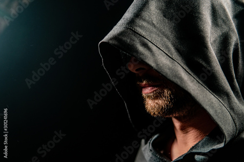 Portrait of a courageous warrior wanderer in a black cloak. Historical fantasy. Halloween