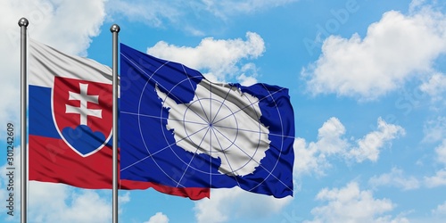 Canvas Print Slovakia and Antarctica flag waving in the wind against white cloudy blue sky together