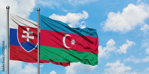 Photography Slovakia and Azerbaijan flag waving in the wind against white cloudy blue sky together