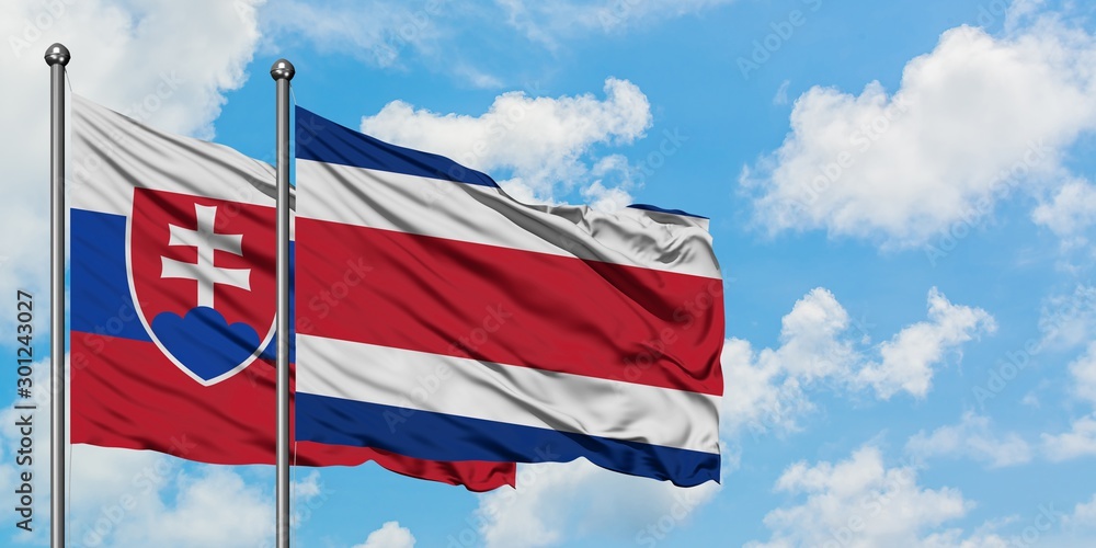 Slovakia and Costa Rica flag waving in the wind against white cloudy blue sky together. Diplomacy concept, international relations.