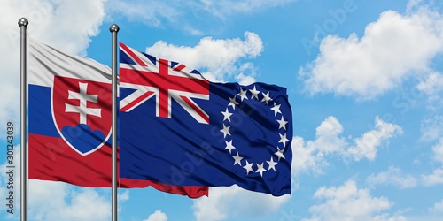 Photography Slovakia and Cook Islands flag waving in the wind against white cloudy blue sky together