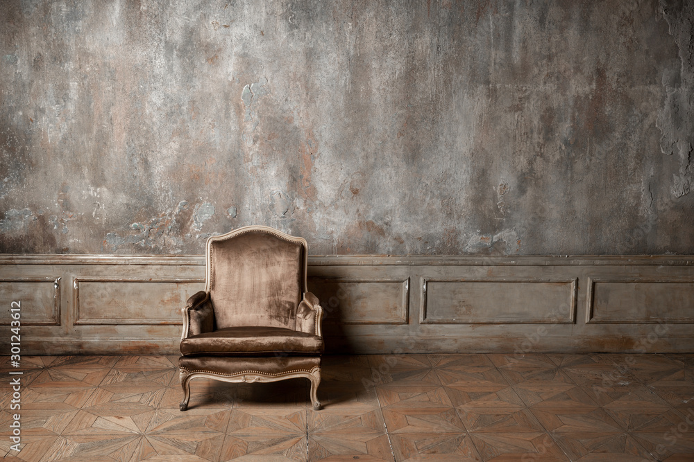 old armchair against a vintage wall - obrazy, fototapety, plakaty 