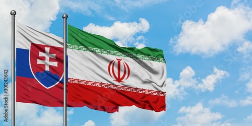 Canvas Print Slovakia and Iran flag waving in the wind against white cloudy blue sky together