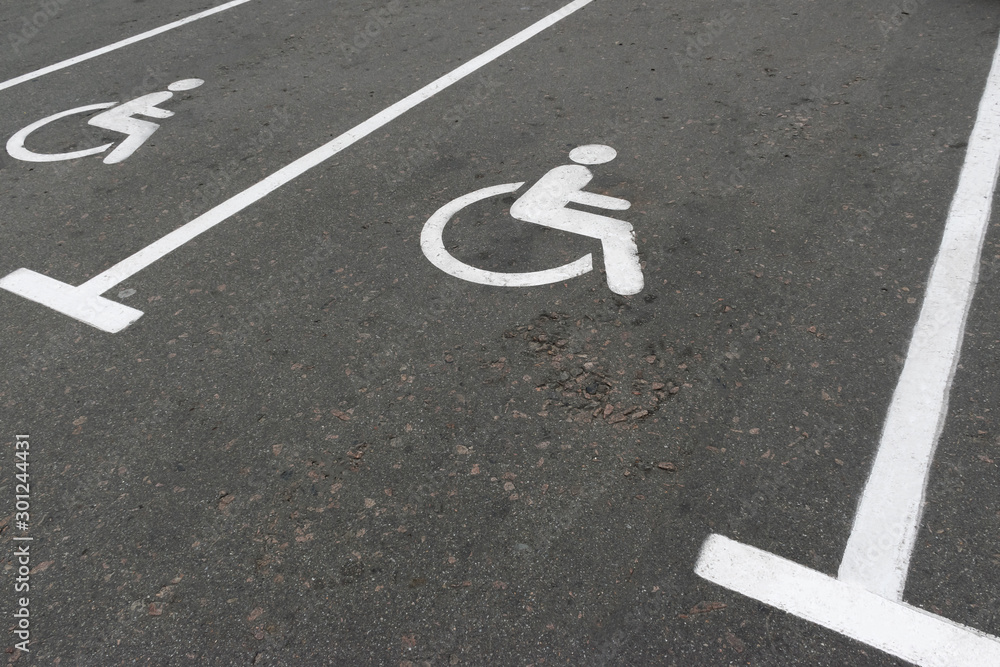 Road marking on the asphalt with parking spaces for the disabled
