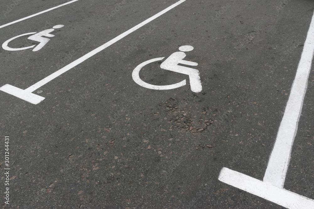 Fototapeta premium Road marking on the asphalt with parking spaces for the disabled